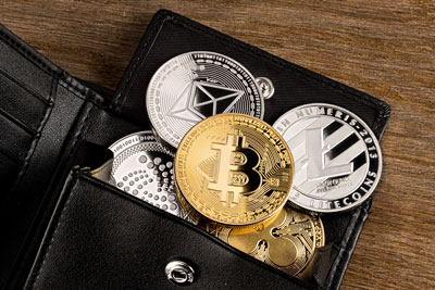 Eine Brieftasche mit Krypto Coins als Symbolbild für Krypto Wallets